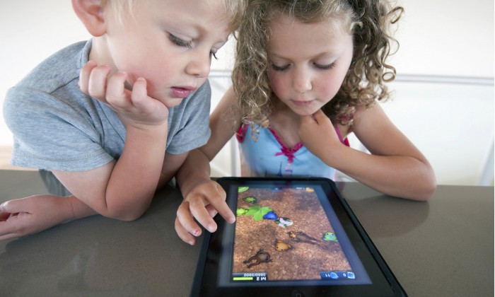 Children playing computer game on an iPad